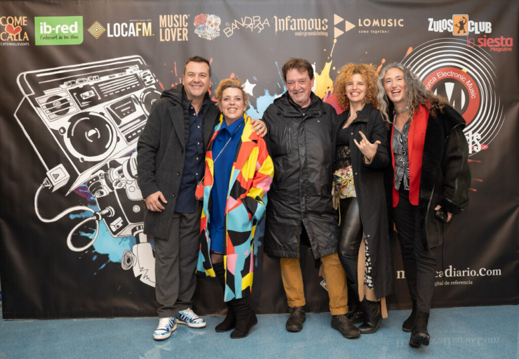 Grupo de personas posando en la Gala MEM Awards con fondo colorido