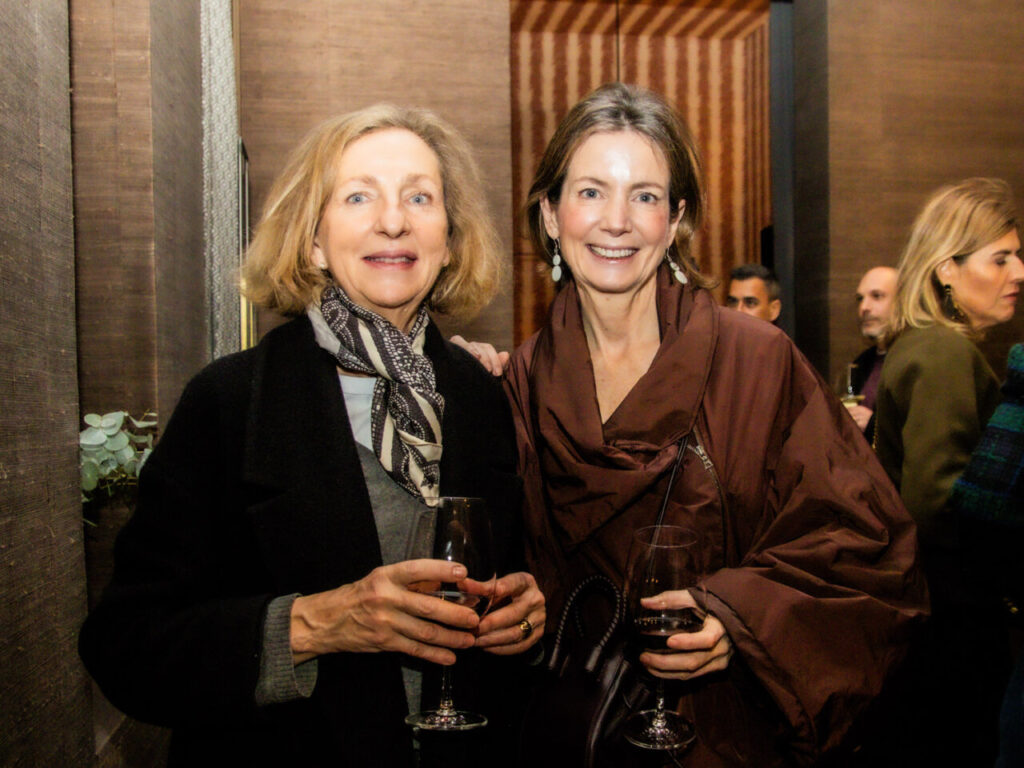 Cupa Stone X Pablo Erroz: Cuando la piedra se convierte en luz 35 Dos mujeres sonrientes sosteniendo copas en un evento social