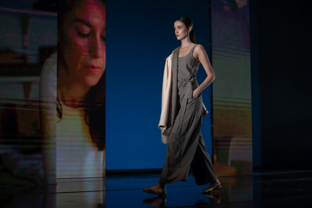 Modelo caminando en pasarela con vestido de diseño contemporáneo
