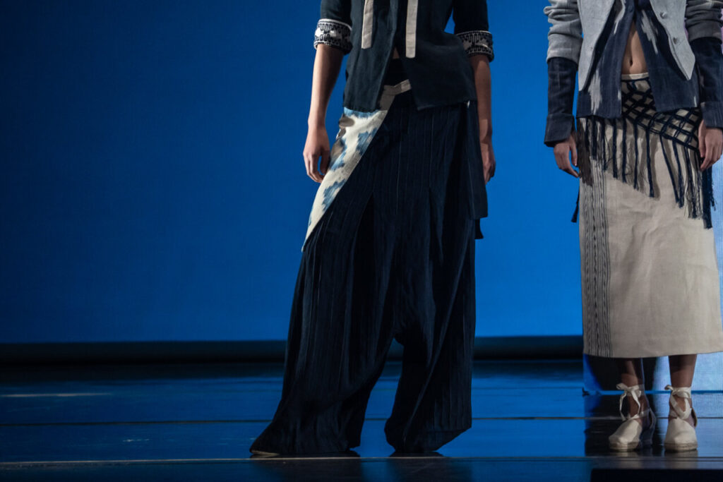 Modelos exhibiendo ropa de la moda artesana en un desfile