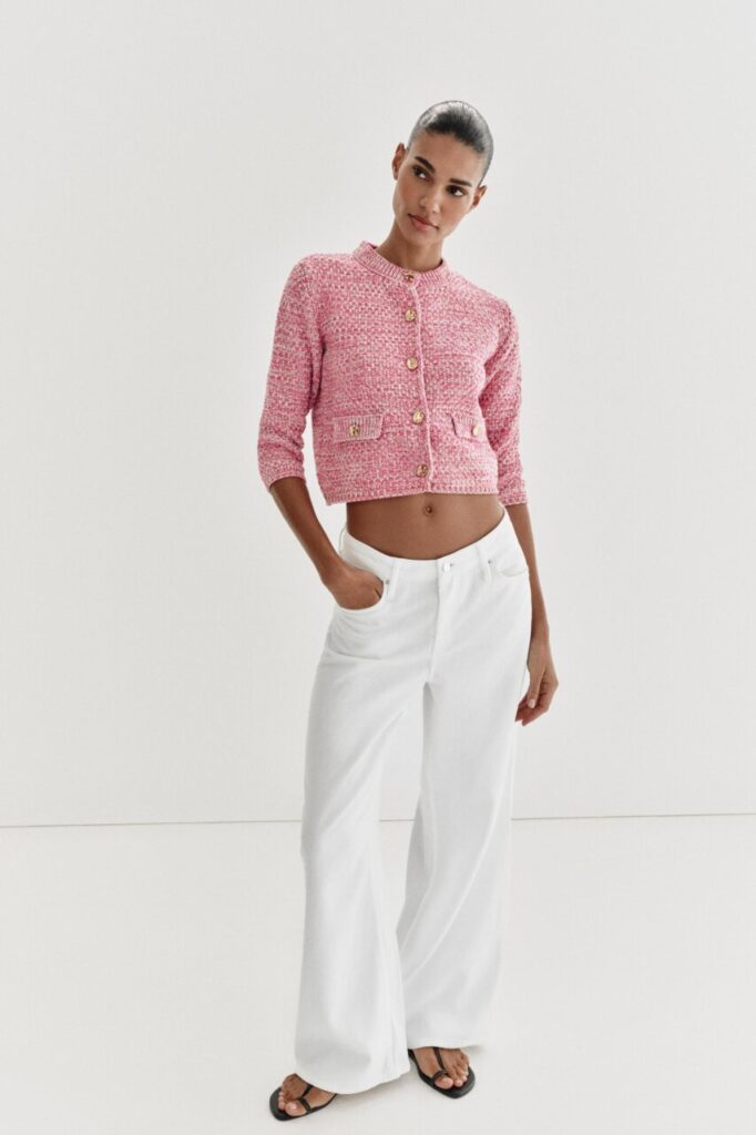 Modelo luciendo chaqueta tipo Chanel de Zara con pantalones blancos
