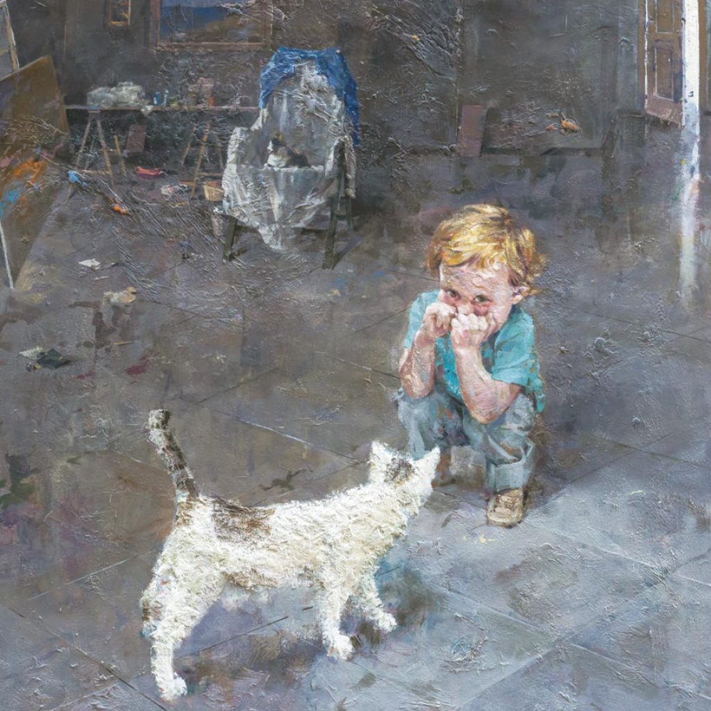 Niño jugando con un gato en un estudio artístico