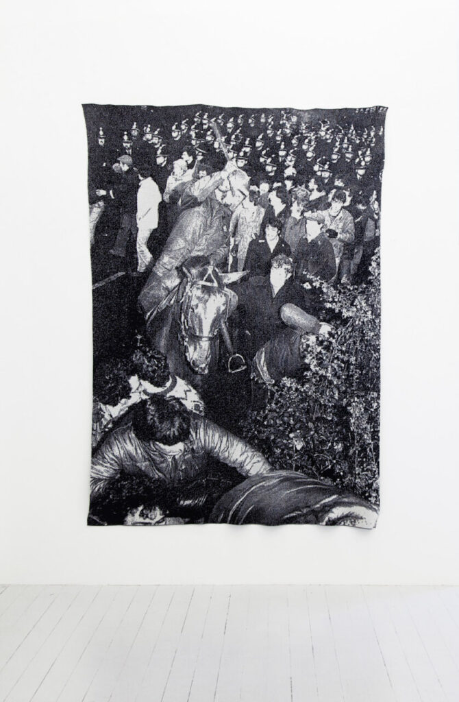 Tapestry artwork depicting a historical event with people and a horse