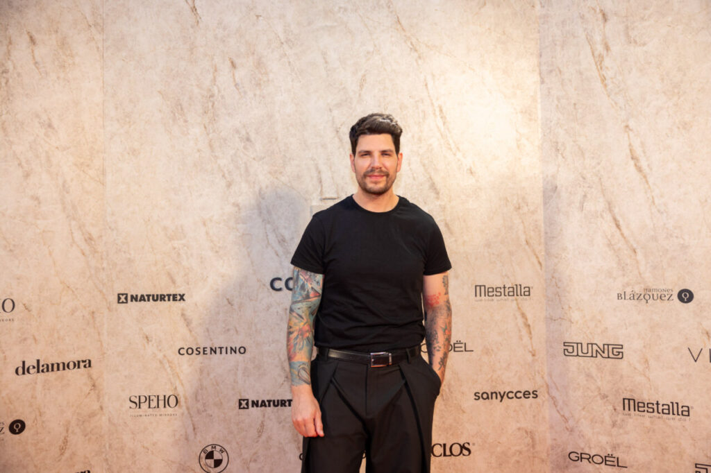 Asistente en evento de diseño con fondo de marcas en Cosentino